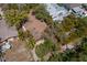 An aerial perspective showing the home's roof, landscaping, and proximity to neighboring properties at 407 Indiana Ave, Crystal Beach, FL 34681