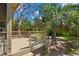 Wood deck surrounded by palm trees and greenery; a perfect outdoor retreat at 407 Indiana Ave, Crystal Beach, FL 34681