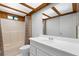 Bathroom featuring a shower and tub combo, white vanity with sink, and a transom window at 407 Indiana Ave, Crystal Beach, FL 34681