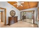 Bright bedroom with unique wood plank ceiling, ceiling fan, large mirrored closet, and ensuite bath at 407 Indiana Ave, Crystal Beach, FL 34681