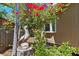 Exterior home view with vibrant bougainvillea and a pelican statue in landscaped garden at 407 Indiana Ave, Crystal Beach, FL 34681