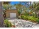 Inviting home with mature landscaping, a large driveway, and an attached garage at 407 Indiana Ave, Crystal Beach, FL 34681