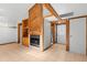 Inviting living room featuring a cozy fireplace, built-in shelves, and tile flooring at 407 Indiana Ave, Crystal Beach, FL 34681