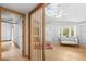 Bright living room features a decorative room divider, wood floors, and built-in shelving at 407 Indiana Ave, Crystal Beach, FL 34681