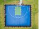 Aerial view of a fenced outdoor basketball court surrounded by green space at 44239 Frontier Dr, Punta Gorda, FL 33982
