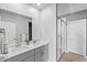 Bright bathroom features double sinks, quartz countertops, and a glass-enclosed shower at 44239 Frontier Dr, Punta Gorda, FL 33982