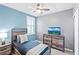 Comfortable bedroom featuring a ceiling fan, stylish furniture, and a neutral color scheme with blue accent wall at 44239 Frontier Dr, Punta Gorda, FL 33982