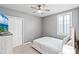 Bedroom features a ceiling fan, a TV on bureau, neutral walls, and a shuttered window at 44239 Frontier Dr, Punta Gorda, FL 33982