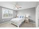 Bedroom features a ceiling fan, neutral walls, and white shuttered window for optimal natural light at 44239 Frontier Dr, Punta Gorda, FL 33982