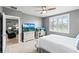 Bedroom features a ceiling fan, TV on bureau, and desk beside a window with white shutters at 44239 Frontier Dr, Punta Gorda, FL 33982
