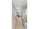Welcoming home hallway with wood flooring, leading to a living area and filled with natural light at 44239 Frontier Dr, Punta Gorda, FL 33982