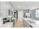 Bright kitchen featuring gray cabinets, stainless steel appliances, and an island with a double sink at 44239 Frontier Dr, Punta Gorda, FL 33982
