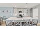 Kitchen island with gray cabinets, white countertop, a double sink, and seating for four at 44239 Frontier Dr, Punta Gorda, FL 33982
