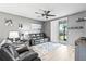 Cozy living room featuring gray walls, hardwood floors, a ceiling fan, and a sliding glass door at 44239 Frontier Dr, Punta Gorda, FL 33982