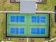 Overhead view of four community tennis courts showcasing a well-maintained playing surface at 44239 Frontier Dr, Punta Gorda, FL 33982