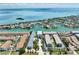 Aerial view of condos featuring a beautiful waterfront, private docks, and landscaped grounds at 455 Pinellas Bayway S # 3B, Tierra Verde, FL 33715