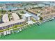 Wide aerial view of a waterfront condominium complex featuring boat docks and neighborhood at 455 Pinellas Bayway S # 3B, Tierra Verde, FL 33715