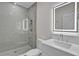 Modern bathroom featuring a glass-enclosed shower, sleek vanity, and a well-lit mirror at 455 Pinellas Bayway S # 3B, Tierra Verde, FL 33715