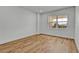 Sunlit bedroom with hardwood floors and a large window offering a view, ideal for relaxation at 455 Pinellas Bayway S # 3B, Tierra Verde, FL 33715