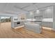 A modern, spacious kitchen featuring gray cabinetry, stainless steel appliances, and a large center island at 455 Pinellas Bayway S # 3B, Tierra Verde, FL 33715