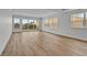 An airy, open living space featuring large windows with views and sleek hardwood flooring at 455 Pinellas Bayway S # 3B, Tierra Verde, FL 33715