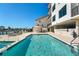 Outdoor pool surrounded by lounge area, dining, and marina views at 455 Pinellas Bayway S # 3B, Tierra Verde, FL 33715