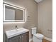 Modern powder room featuring illuminated mirror, gray vanity and fixtures at 455 Pinellas Bayway S # 3B, Tierra Verde, FL 33715