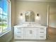 Bright bathroom featuring a modern vanity and large window for natural light at 4716 W Lawn Ave, Tampa, FL 33611