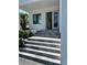Inviting home entrance with layered stone steps leading to a bright white exterior at 4716 W Lawn Ave, Tampa, FL 33611