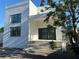 Modern, two-story home with a stucco facade and large windows for ample natural light at 4716 W Lawn Ave, Tampa, FL 33611