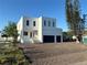 Modern two-story home featuring a clean, minimalist design with a two-car garage at 4716 W Lawn Ave, Tampa, FL 33611