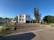 Modern two-story home with a white exterior, black garage doors, and a newly landscaped front yard at 4716 W Lawn Ave, Tampa, FL 33611