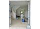 View through the front door into the spacious interior with curved staircase and arched doorways at 4716 W Lawn Ave, Tampa, FL 33611