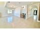 Spacious living room featuring a wet bar, unique light fixtures and access to other rooms via an arched hallway at 4716 W Lawn Ave, Tampa, FL 33611