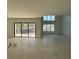 Bright, open-concept living room with large sliding glass doors to the backyard at 4716 W Lawn Ave, Tampa, FL 33611