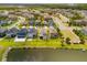 Aerial view shows the lake behind properties in a well-planned community at 4784 San Martino Dr, Wesley Chapel, FL 33543
