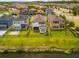 Aerial view of backyards shows proximity to the lake and surrounding neighborhood at 4784 San Martino Dr, Wesley Chapel, FL 33543