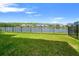 The backyard offers a large grassy area with a lake view at 4784 San Martino Dr, Wesley Chapel, FL 33543