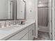 Bathroom featuring double sinks, chrome faucets, and a shower with a gray curtain at 4784 San Martino Dr, Wesley Chapel, FL 33543