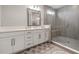 This bathroom features a glass shower, white cabinets, and modern fixtures at 4784 San Martino Dr, Wesley Chapel, FL 33543