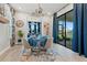 Charming dining area with blue accents, pendant lighting, and seamless access to the outdoor patio at 4784 San Martino Dr, Wesley Chapel, FL 33543