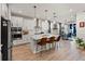 Modern kitchen featuring stainless steel appliances, a central island with seating, and bright, white cabinetry at 4784 San Martino Dr, Wesley Chapel, FL 33543