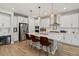 Bright kitchen with white cabinets, stainless appliances, and a large center island with bar seating at 4784 San Martino Dr, Wesley Chapel, FL 33543