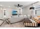 Comfortable living room with a ceiling fan, gray sofa, and decorative accents at 4784 San Martino Dr, Wesley Chapel, FL 33543