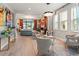 Open-concept living space features modern décor, ample seating, and views of the lake at 4784 San Martino Dr, Wesley Chapel, FL 33543