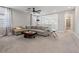 Spacious living room with gray sofa, carpet, and natural light at 4784 San Martino Dr, Wesley Chapel, FL 33543