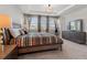 Bright bedroom with large windows, tray ceiling, and carpet floors offers a restful retreat at 4784 San Martino Dr, Wesley Chapel, FL 33543