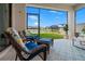 Relaxing screened patio with cozy seating offering serene lake views and a peaceful outdoor retreat at 4784 San Martino Dr, Wesley Chapel, FL 33543