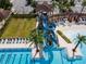Aerial close-up of the blue waterslide that flows into the community pool at 4784 San Martino Dr, Wesley Chapel, FL 33543