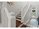 A staircase with white railings and wood steps leads to the front door at 4784 San Martino Dr, Wesley Chapel, FL 33543